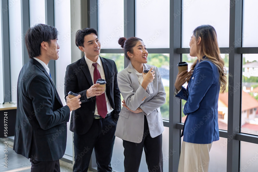 Business meeting of business people in office formal wear stand hold glass of coffee on break time Business meeting of business people in office formal wear stand hold glass of coffee on break time
