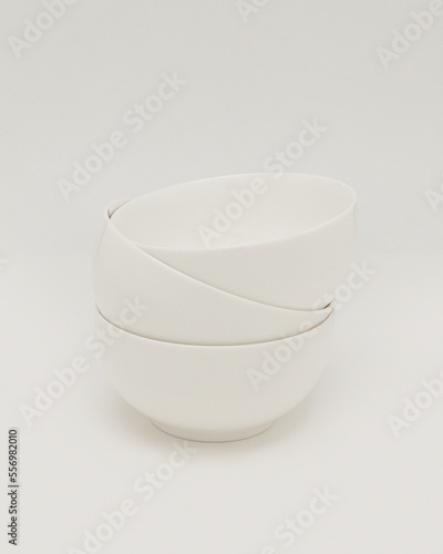 a stack of white soup bowls 