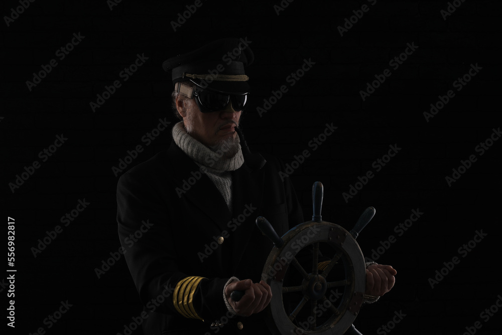 ship captain at the steering wheel
