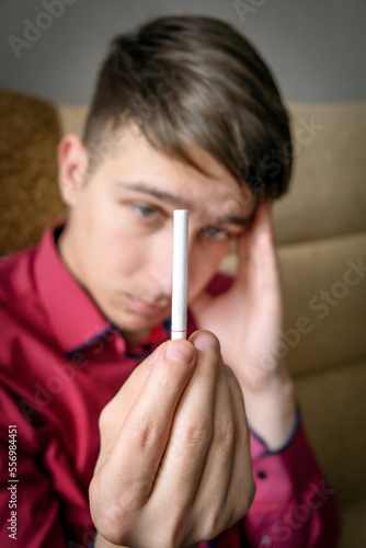 Young Man looking at a Cigarette photo