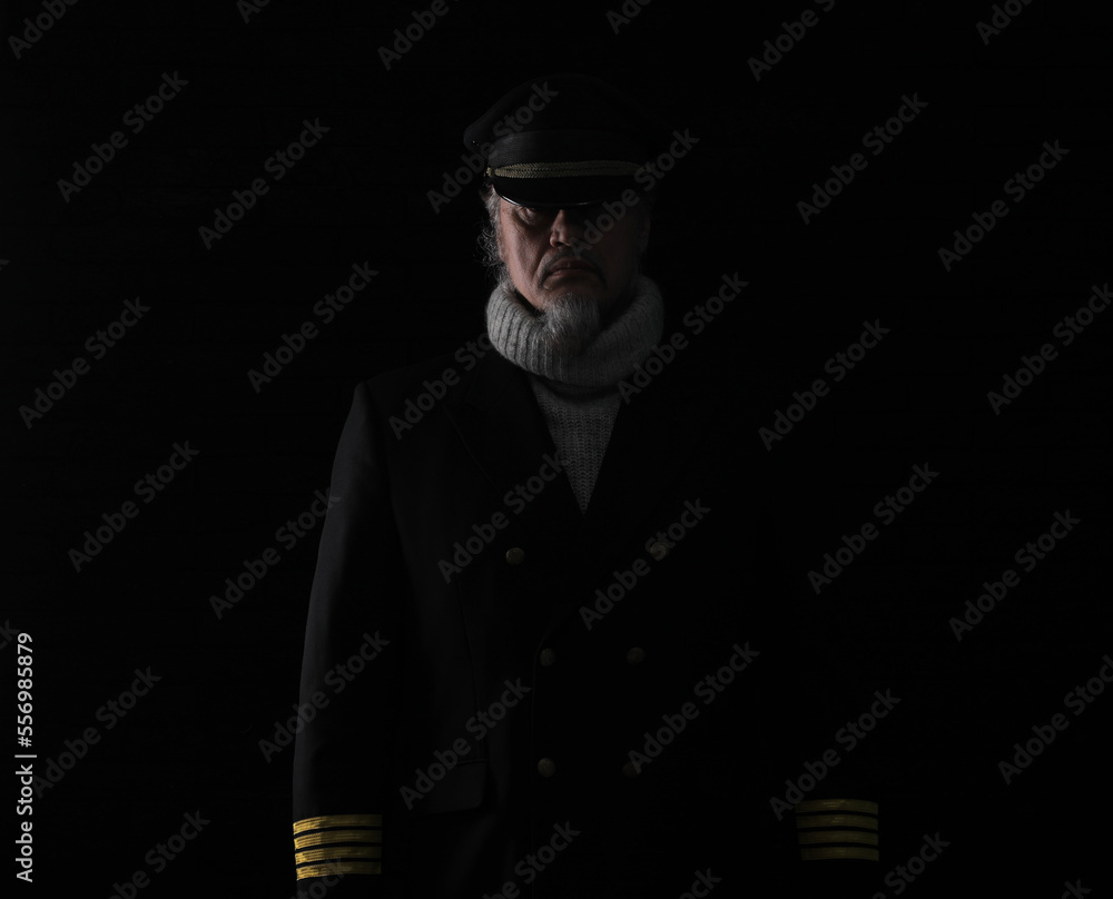 portrait of a ship captain on a black background