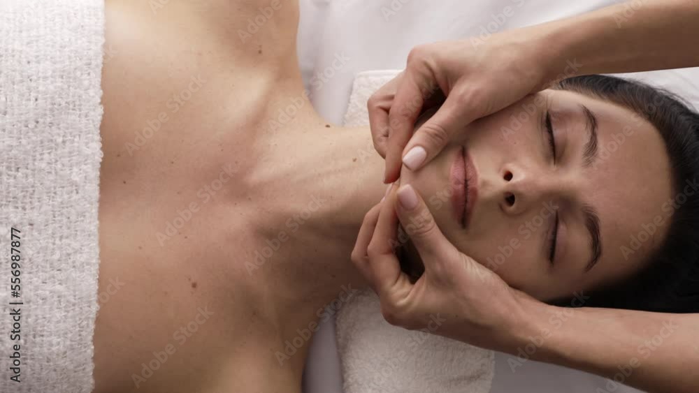 An attractive woman receiving facial treatment in the spa salon An attractive woman receiving facial treatment in the spa salon