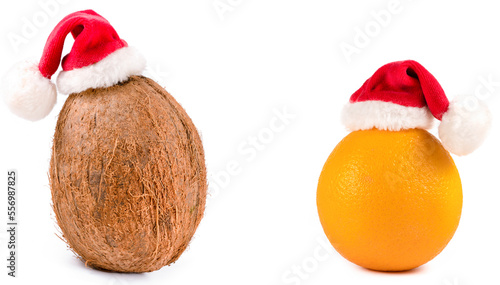 orange  and coconut in a Christmas hat on a white background