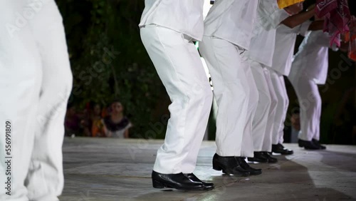 Closeup of men and women dancing a Mexican cultural folk dance sharing the different ethnic dances of the Yucatan in Merida in slow motion.