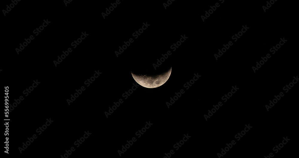 Amazing crescent moon on dark blue night sky background, starry universe, nebula and galaxies with noise and grainy, selective focus. Amazing crescent moon on dark blue night sky background, starry universe, nebula and galaxies with noise and grainy, selective focus.
