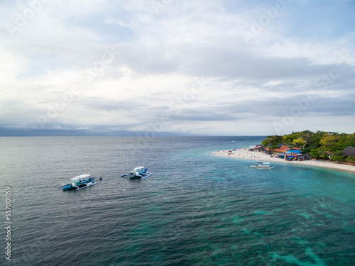 White Beach Moalboal in Cebu, Palawan, Philippines. Boat and Ocean Water and Beach. © Mindaugas Dulinskas