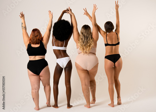 Group of women with different body and ethnicity dancing on the limbo together. Power and strength of women.  Body positivity concept photo