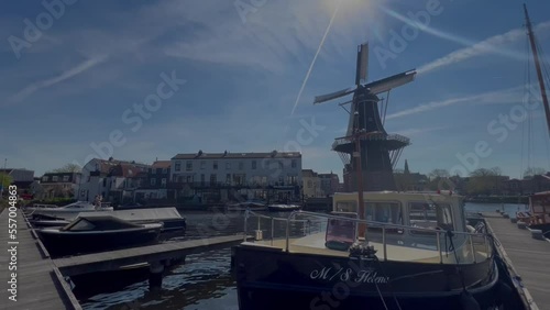 Street view of canal marina and windmill in Netherlands
