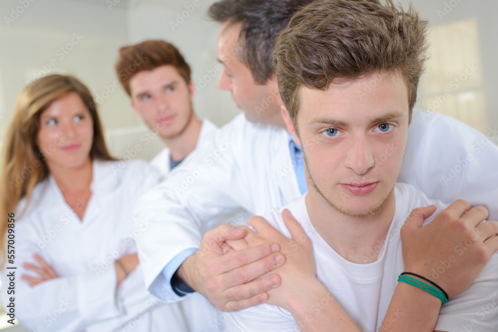 students observing a chiropractor demonstration students observing a chiropractor demonstration