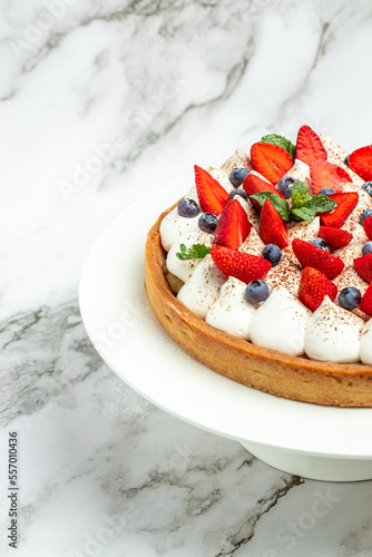 Homemade tart pie or cake with whipped cream and fresh raspberry. Food recipe background. Close up