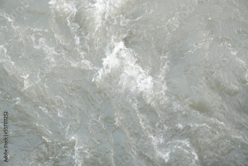 Fast moving whisky water on current stream river waves in the river