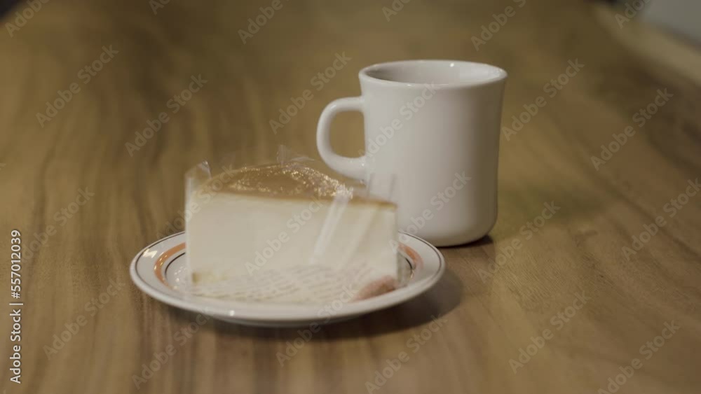 Cafe latte and cheese curds cake so sweet on wooden table for breakfast.
Cafe latte and cheese curds cake so sweet on wooden table for breakfast.