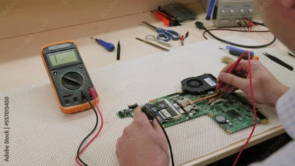 Close-up image of technician man hand measuring electrical voltage of computer mainboard by using digital multimeter. Maintenance and repair computer hardware service concept. Close-up image of technician man hand measuring electrical voltage of computer mainboard by using digital multimeter. Maintenance and repair computer hardware service concept.