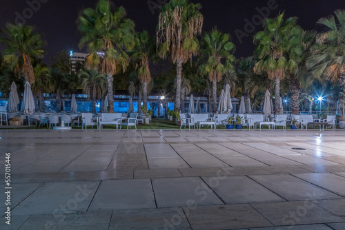 Public promenade in Malaga, Parmeral de las Sorpresas at late night in the full colors of the night city lights. Modern urban architecture, Harbour quay at night. Andalusia, Spain