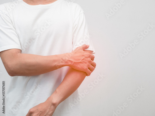 Male employee elbow pain from hard working office syndrome