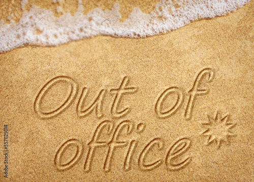 Out of office sign on beach sand