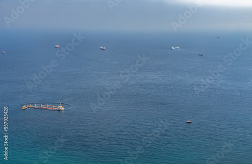 October 17th, 2022. Sea disaster in Algeciras Bay. View from The Rock of Gibraltar. Closeup photo. A close up of the sinking ship and the auxiliary and rescue units working around it. Gibraltar, UK