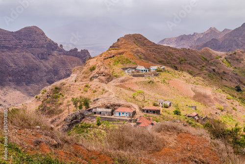 Stone houses and a footpath on a mountain range with bushes and grass on Santiago Island, Cabo Verde