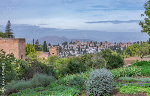 Amazing panorama of Granada city and Alhambra's Alcazaba fortress. Scenic view from Generalife gardens on a sunny day with blue sky above. Granada, Andalusia, Spain.                                   