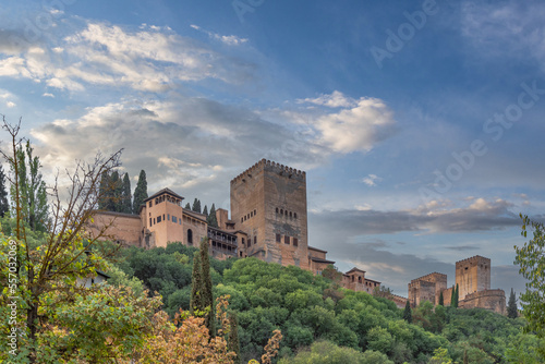 Amazing view of the Sabika hill with the ruins of the ramparts, watchtowers and Alhambra Palace  from the Carrera Del Darro street. Sunny day with an amazing sky.