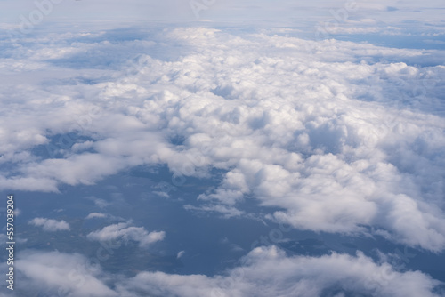 The view from the plane window to the clouds and the ground. The landscape of the earth's surface