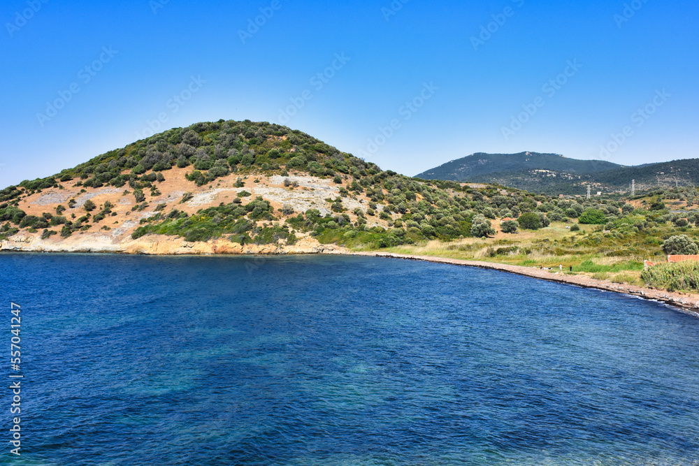 A virgin bay in İzmir Foça. Aegean sea, mountains and natural vegetation of the Aegean covered with maquis. Antique Phokaia in Izmir