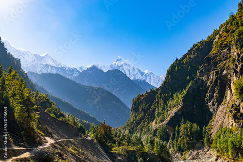Annapurna circuit trek path with sweeping view of the mountains and valleys on a sunny fall day photo