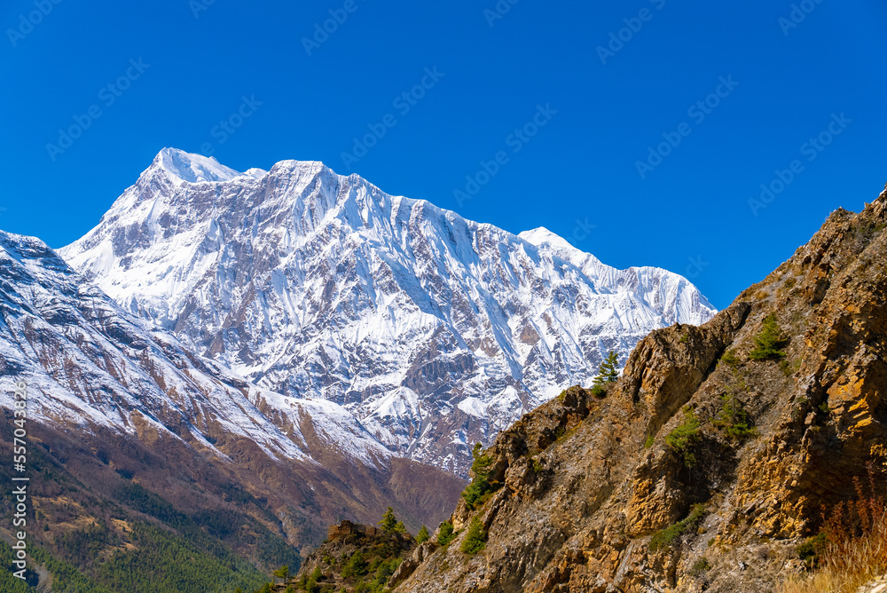 Picturesque landscape of the Annapurna Circuit trek  with footpath on a sunny fall day