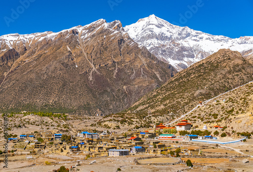 High altitude himalayan town of Ngawal with Annapurna mountain range in the distance. Shot on a sunny fall day photo