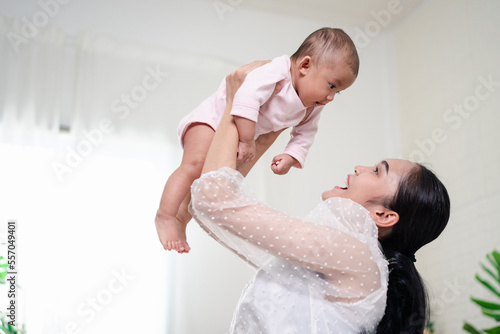 Mother Parenting and newborn birth life. Mom and baby boy playing in sunny bedroom, Family having fun together. childcare, maternity concept.