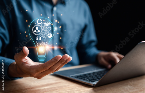 Man hand holding lightbulb which for mind, creative, idea, innovation, motivation planning development leadership and customer target group concept...