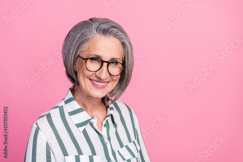 Photo portrait headshot of cheerful pensioner businesswoman wear stylish striped shirt smiling enjoy her company isolated on pink color background