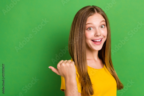 Profile photo of cheerful funky girl toothy smile indicate thumb finger empty space isolated on green color background