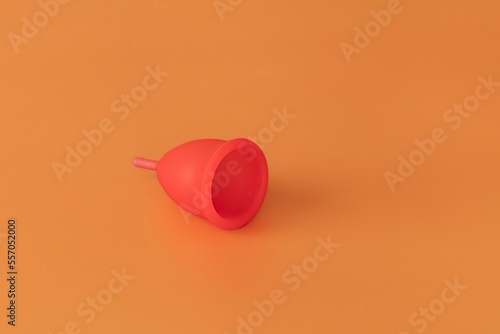 A red menstrual cup in neutral background. Alternative ecological method for woman.  During Menstrual cycle.  photo