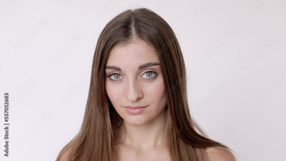 Portrait of a pretty young Middle Eastern model with bare shoulders. The model is isolated on a white studio background. Portrait of a pretty young Middle Eastern model with bare shoulders. The model is isolated on a white studio background.