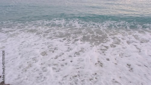 Sea waves on the beach, ocean tides flow on the shore, calm seascape footage.