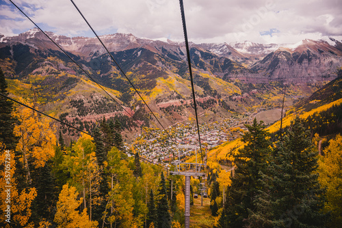 Landscape of sceneic views in Telluride, Colorado in the fall with colorful aspen trees, gondola, and purple mountain background photo