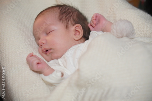 Close-up portrait of adorable baby boy sleeping in bed, newborn baby concept. 