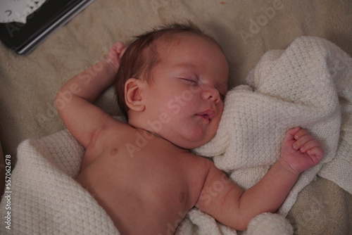 Close-up portrait of adorable baby boy sleeping in bed, newborn baby concept. 