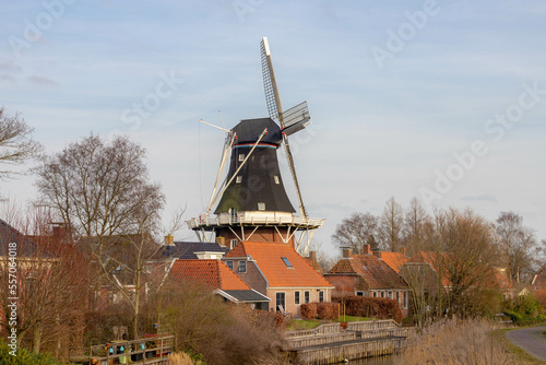 Landscape view with traditional Dutch windmill, Mensingeweer is a small village, The municipality of Het Hogeland, Groningen, Netherlands, The Pieterpad is a long distance walking route in Holland. photo