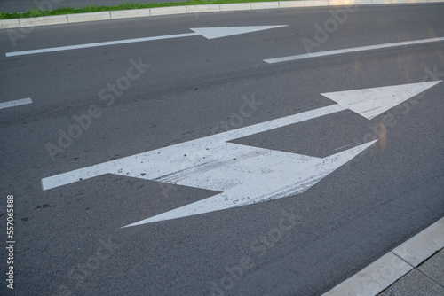 a close-up of a sign drawn on the road signifying a right turn or straight ahead. Tools for regulating traffic rules. Road signs.