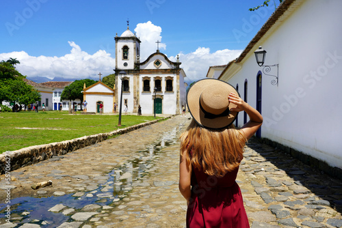 Tourism in Paraty, Brazil. Girl walking in the historic town of Paraty, UNESCO World Heritage Site, Rio de Janeiro, Brazil. photo