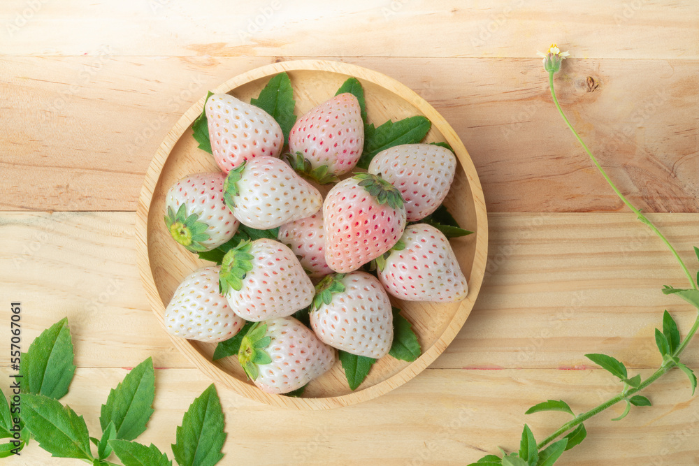 White and Pink snow Strawberries on wooden Background, Fresh Pink Snow Strawberry in wooden plate on wooden background. White and Pink snow Strawberries on wooden Background, Fresh Pink Snow Strawberry in wooden plate on wooden background.