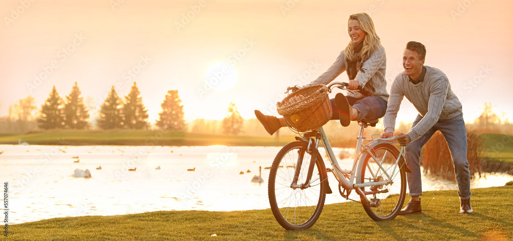 Obraz premium Happy young couple with bicycle having fun outdoors, space for text. Banner design