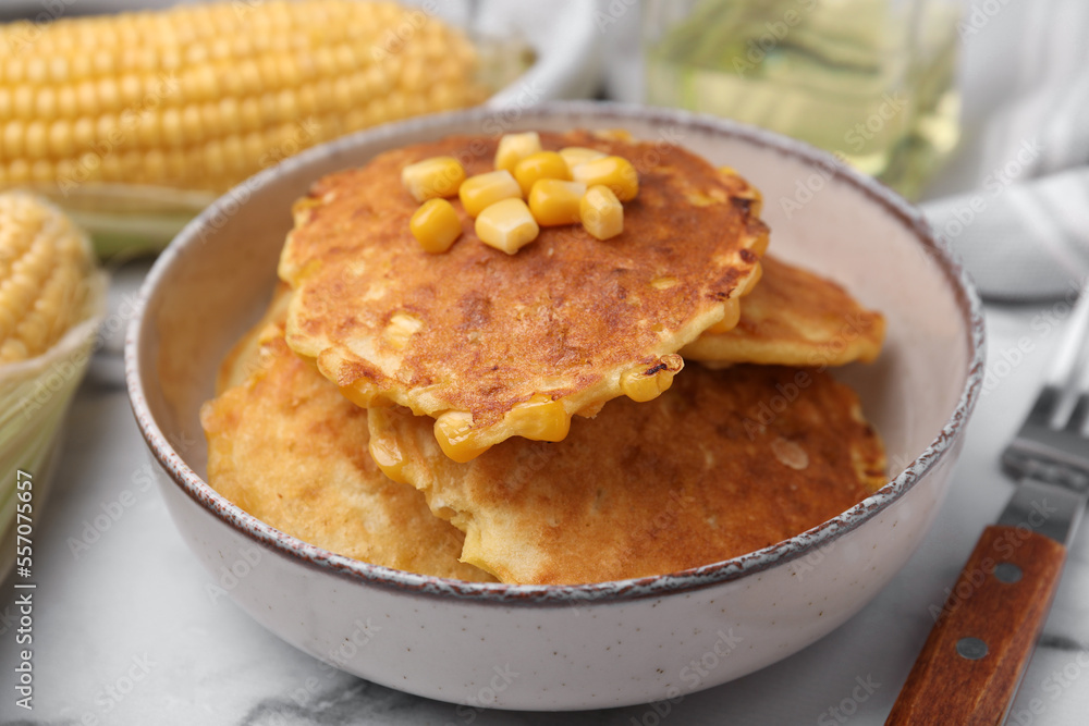 Tasty corn pancakes in bowl on table, closeup Tasty corn pancakes in bowl on table, closeup
