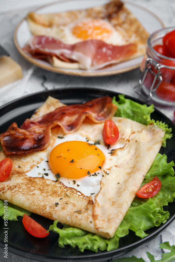 Delicious crepe with egg on table, closeup. Breton galette