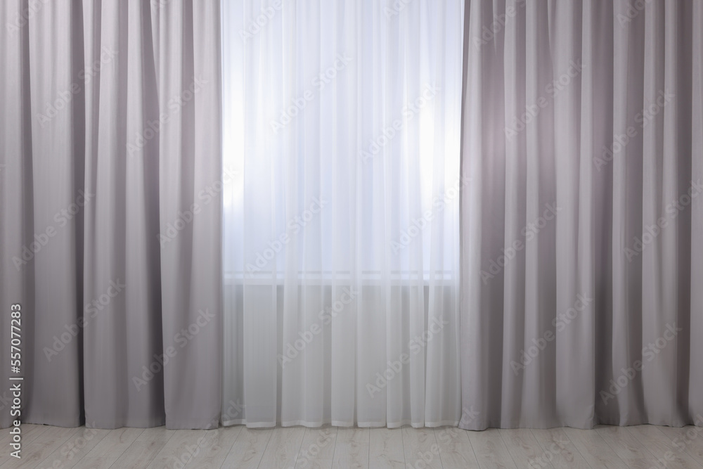 Light grey window curtains and white tulle indoors Light grey window curtains and white tulle indoors