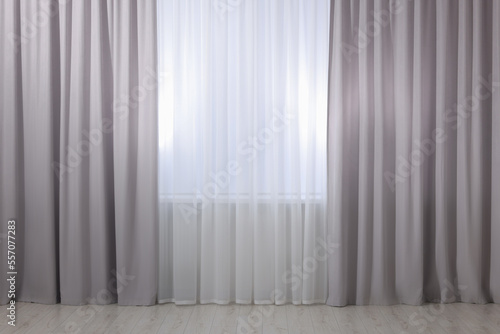 Light grey window curtains and white tulle indoors