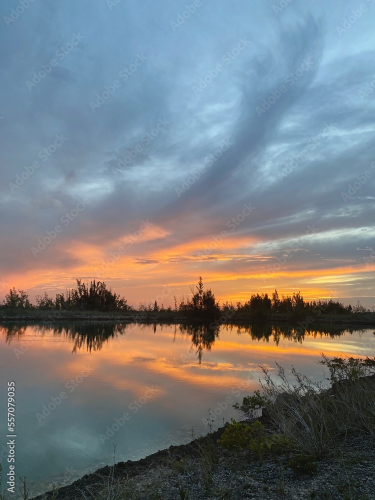 sunrise over canal and island trees