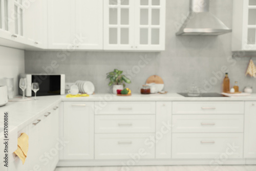 White cosy kitchen with furniture  blurred view. Interior design